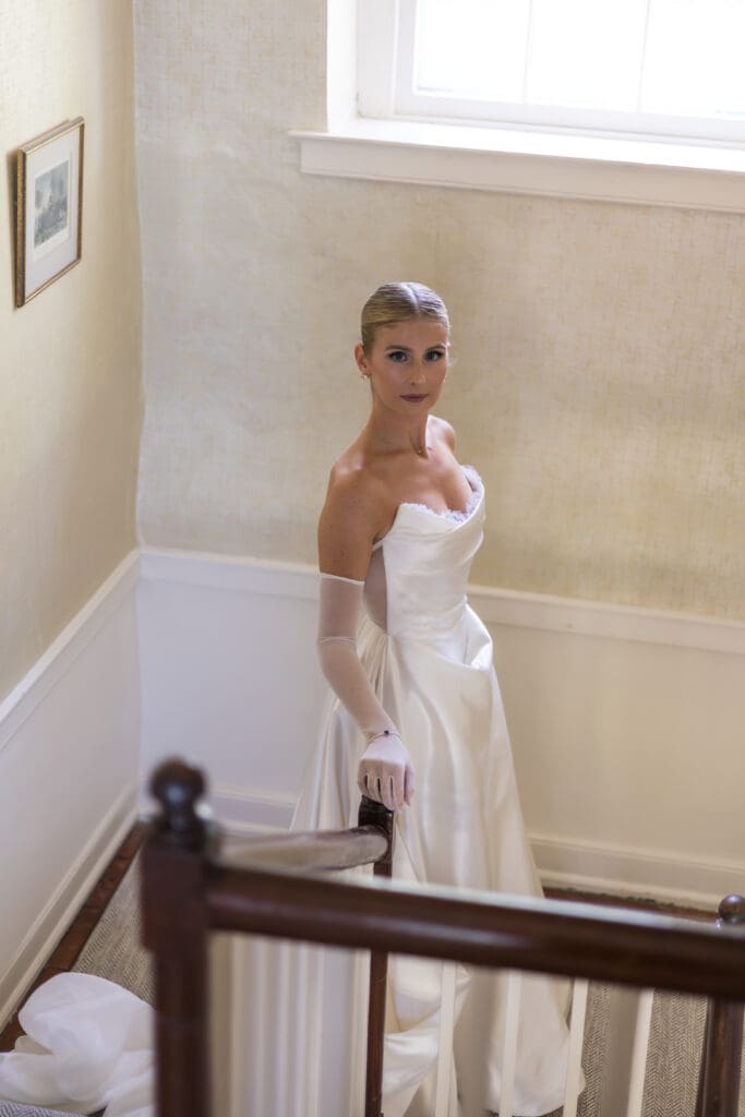 bride wearing satin wedding gown with sapphire bracelet detail something blue
