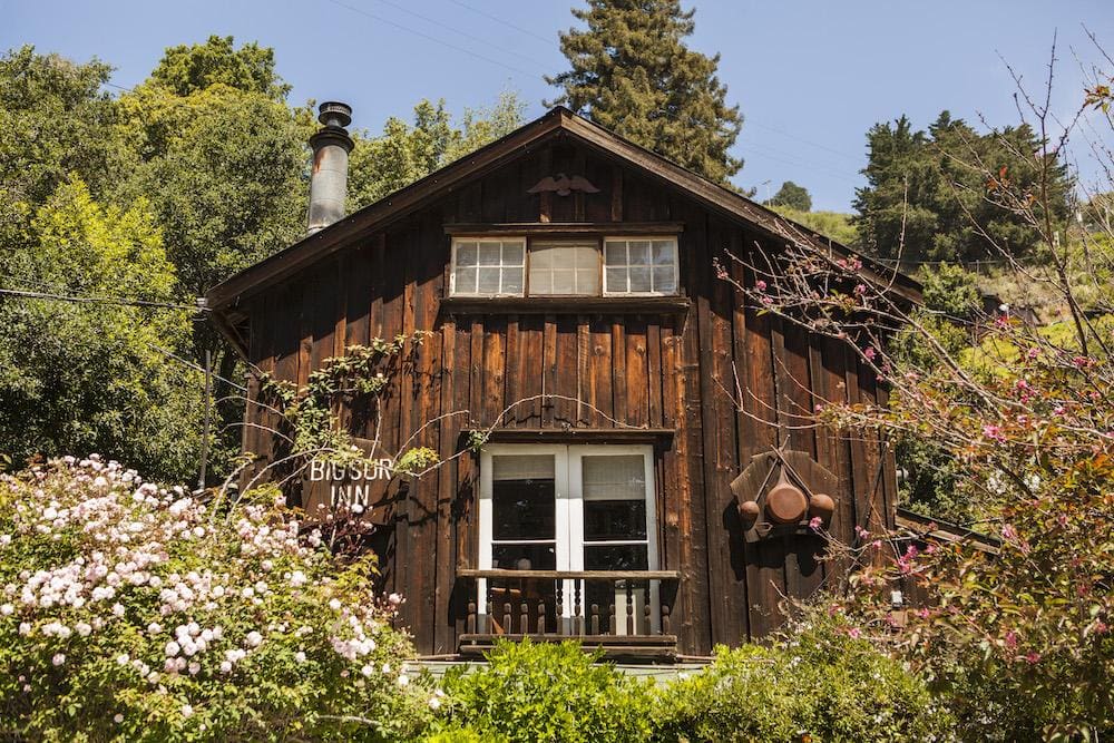 Historic rustic cabins at Deetjen’s Big Sur Inn surrounded by mossy redwoods
