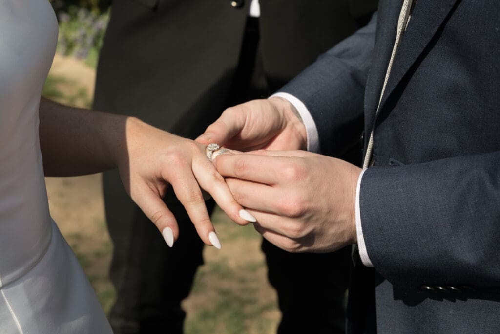 Couple holding hands during emotional ceremony officiated by best friend