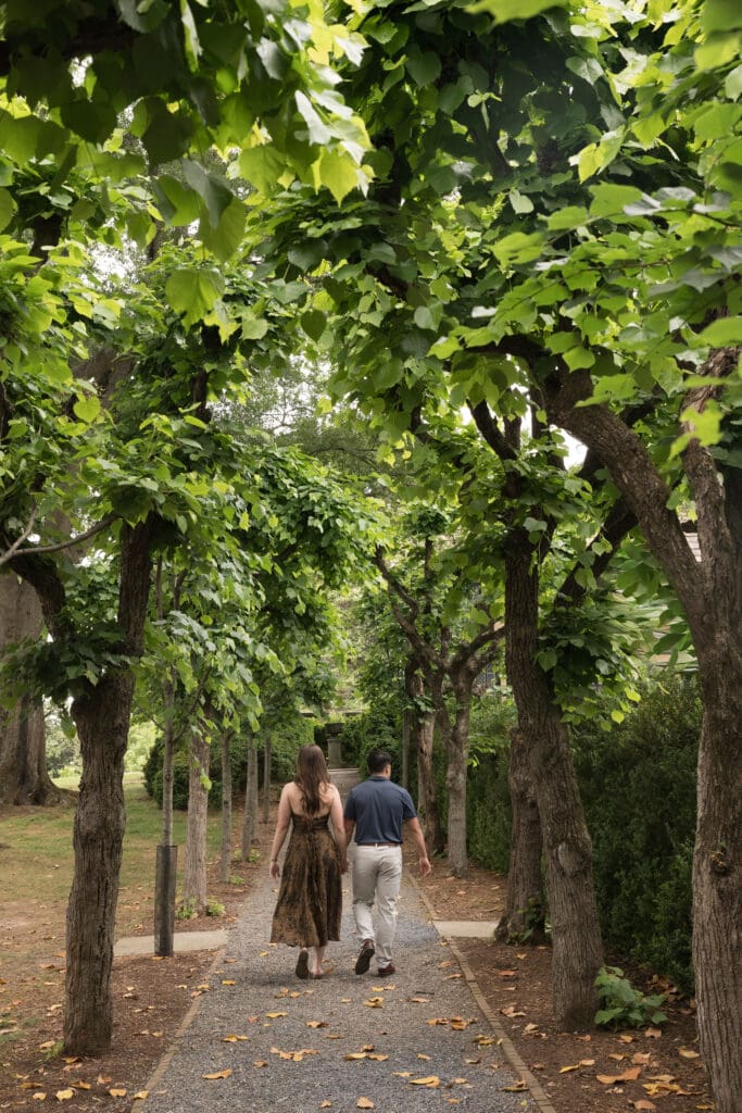 Couple walking hand in hand through the gardens at Agecroft Hall & Gardens