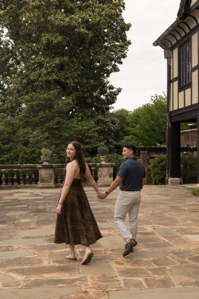 Couple standing in front of Agecroft Hall & Gardens in Richmond, Virginia