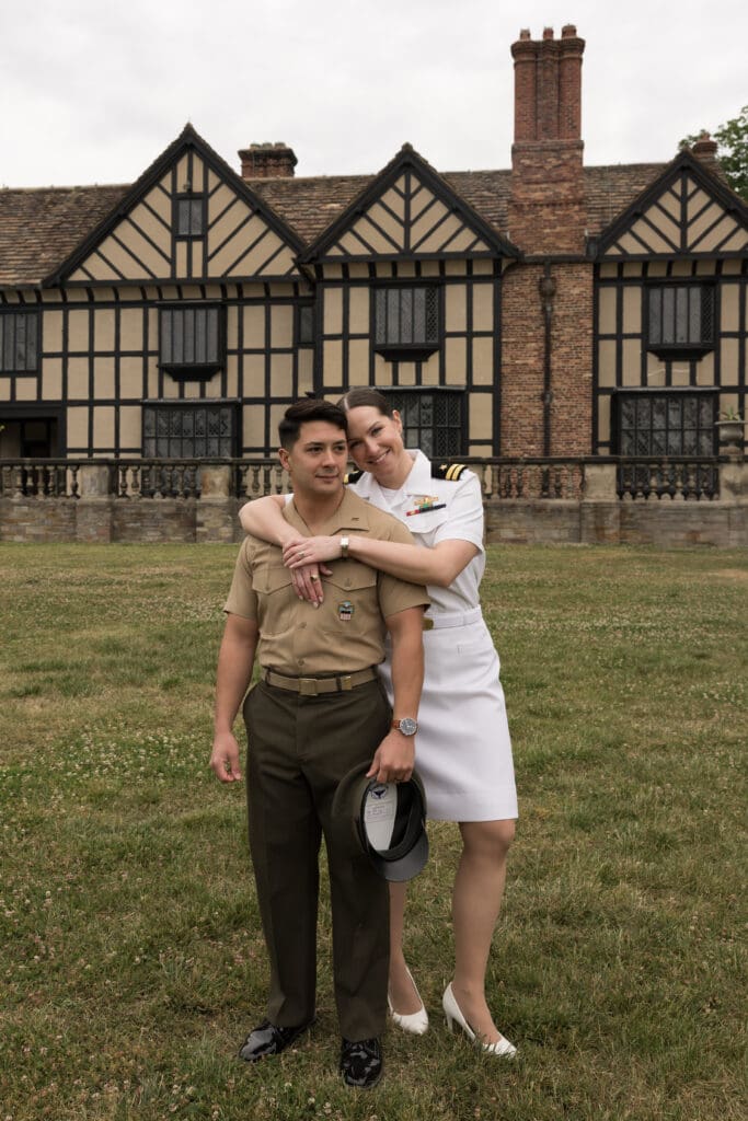 Couple in military dress uniforms standing in front of Agecroft Hall in Richmond, Virginia