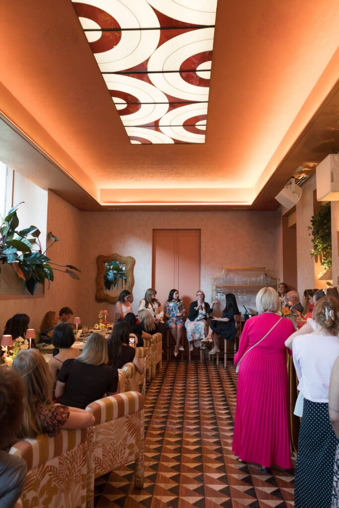 Modern event space at River Club DC decorated with vibrant florals and colorful design elements.